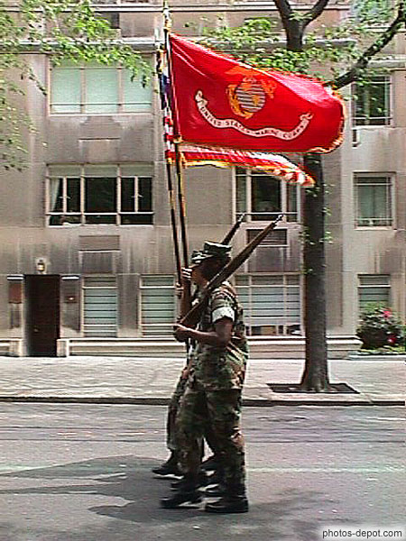 photo de défilé de soldats au drapeau rouge