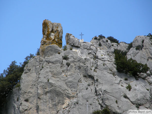 photo de surmontant l'ermitage, une croix de fer préside sur le plus haut rocher